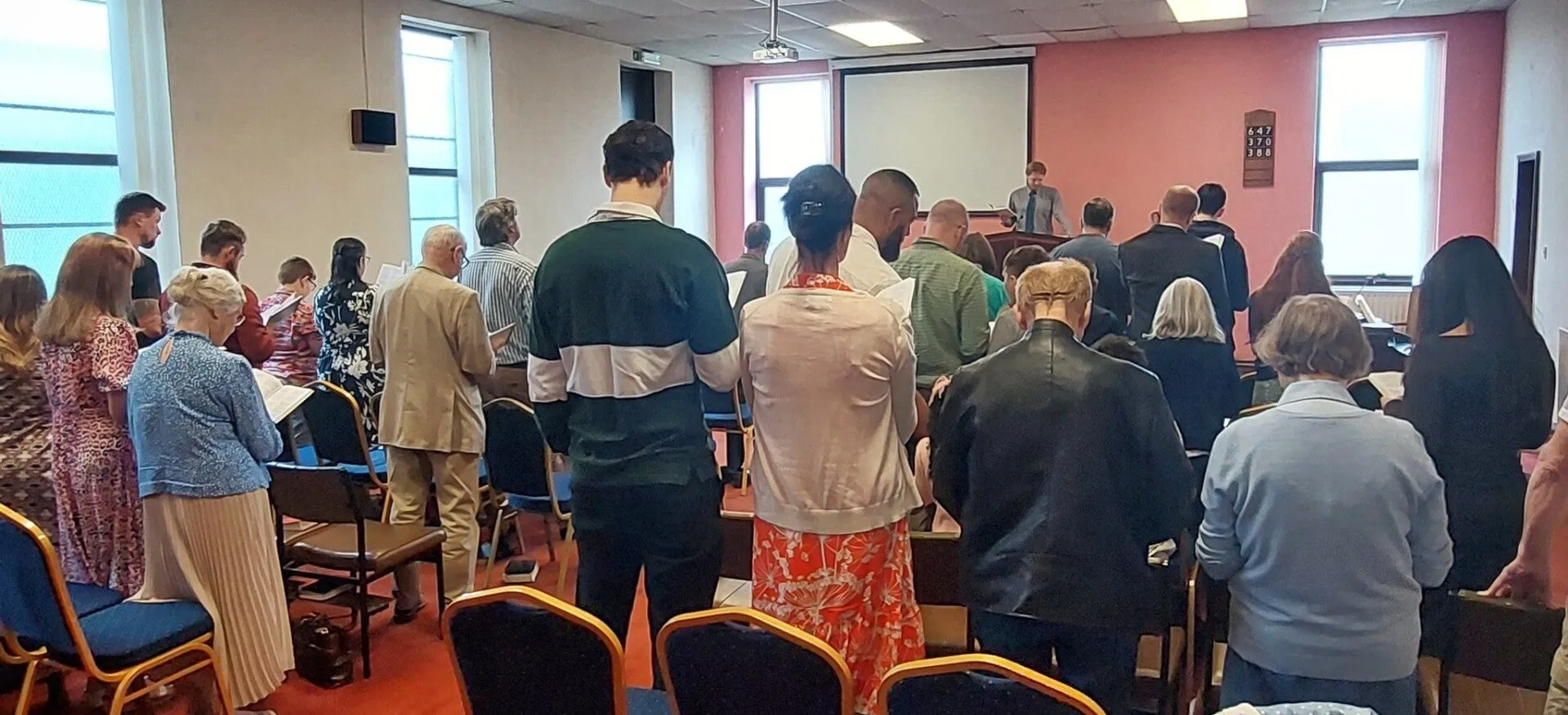 The congregation standing to sing during a Sunday service